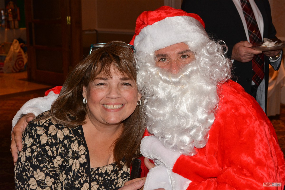Odalys Banks, Director of First Choice, smiles with Santa!