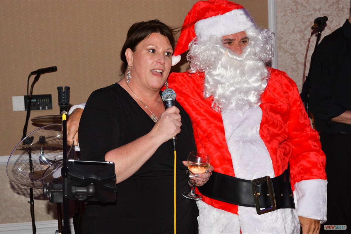 Santa sings a Christmas tune with Past President and vocalist Cindi Rand