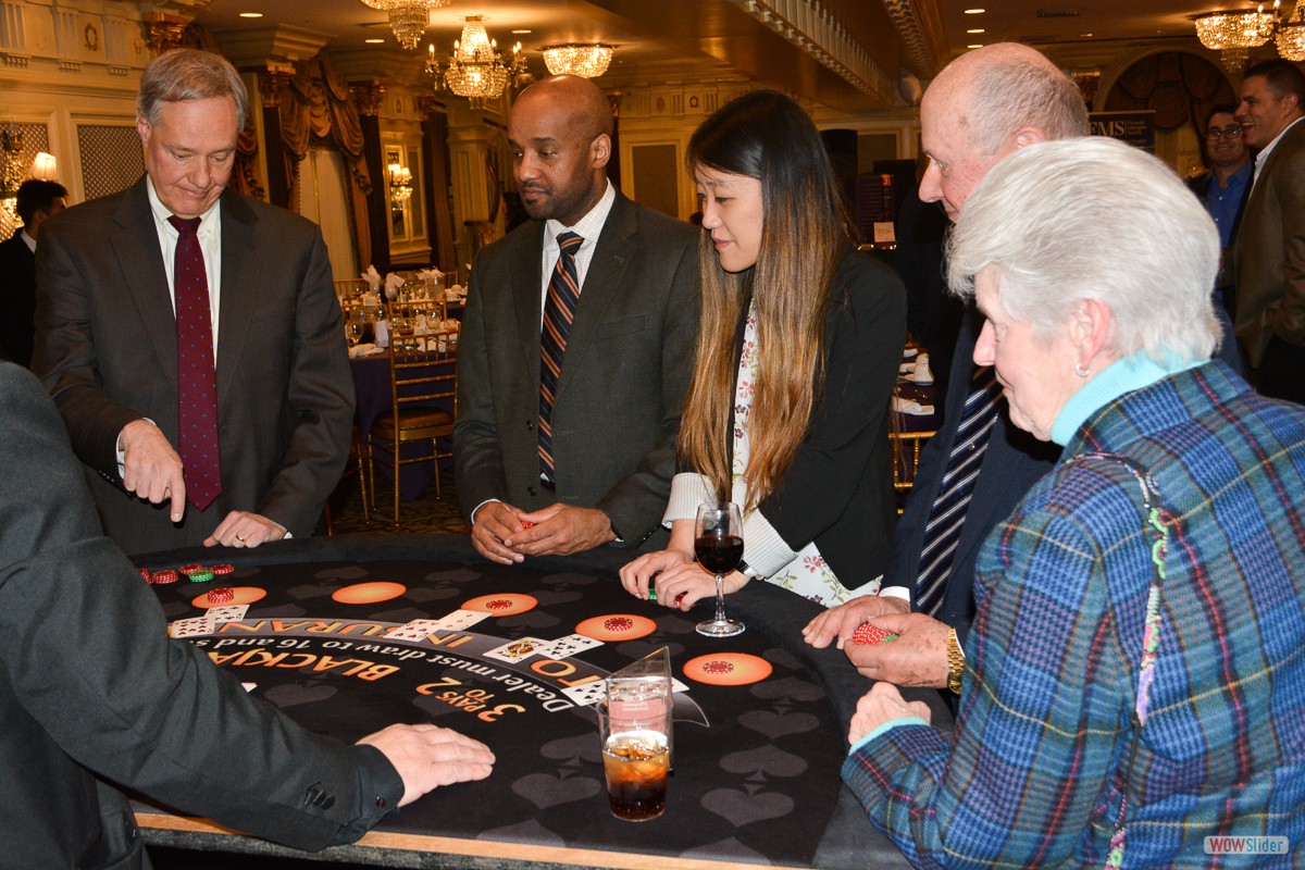 Members crowd the blackjack table