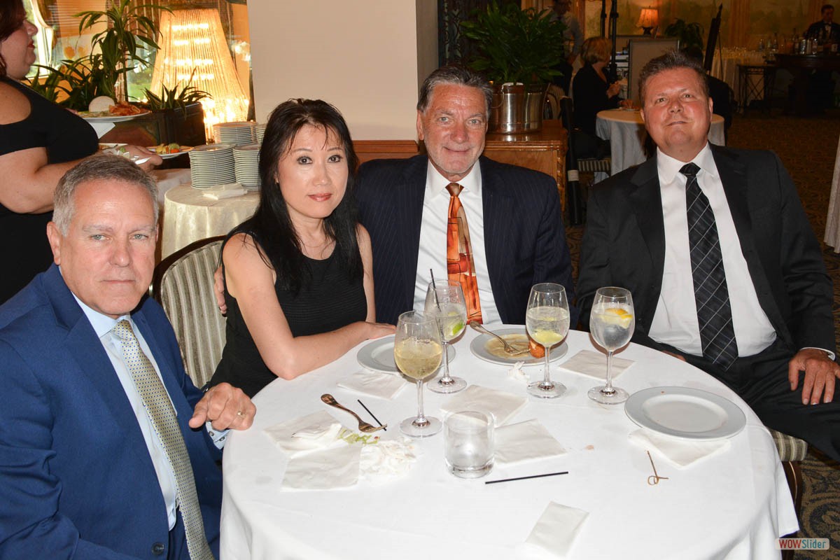 Members and guests enjoy the cocktail reception  - George Niemczyk (2nd r.) and Suzie Wu with Mike Volpe (r.)