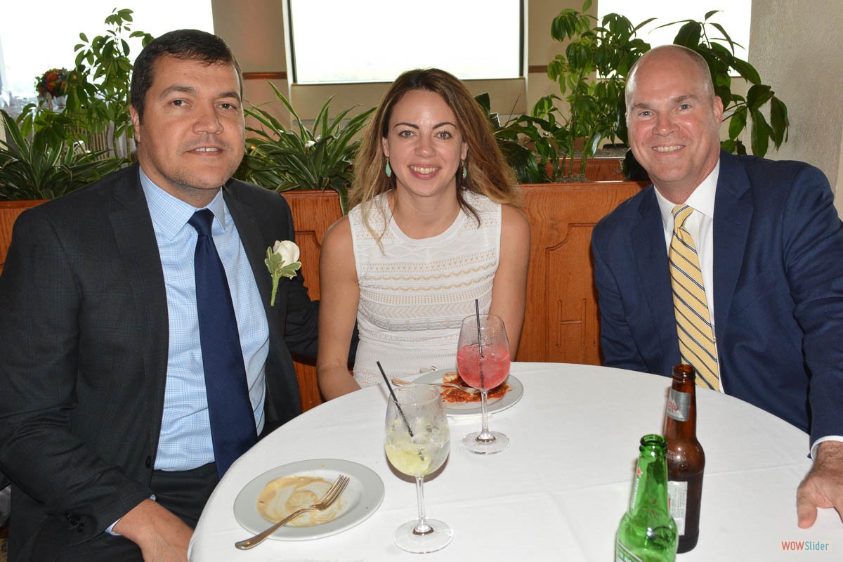 Incoming Vice President Adriano Duarte (l.) and spouse Monica are joined by a guest.