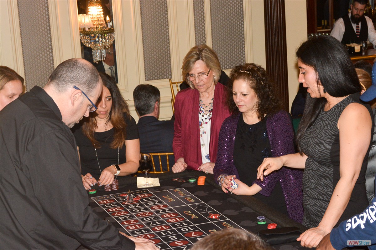 Chapter Past-President Grace Cruz-Beyer (c.) plays a roulette strategy.