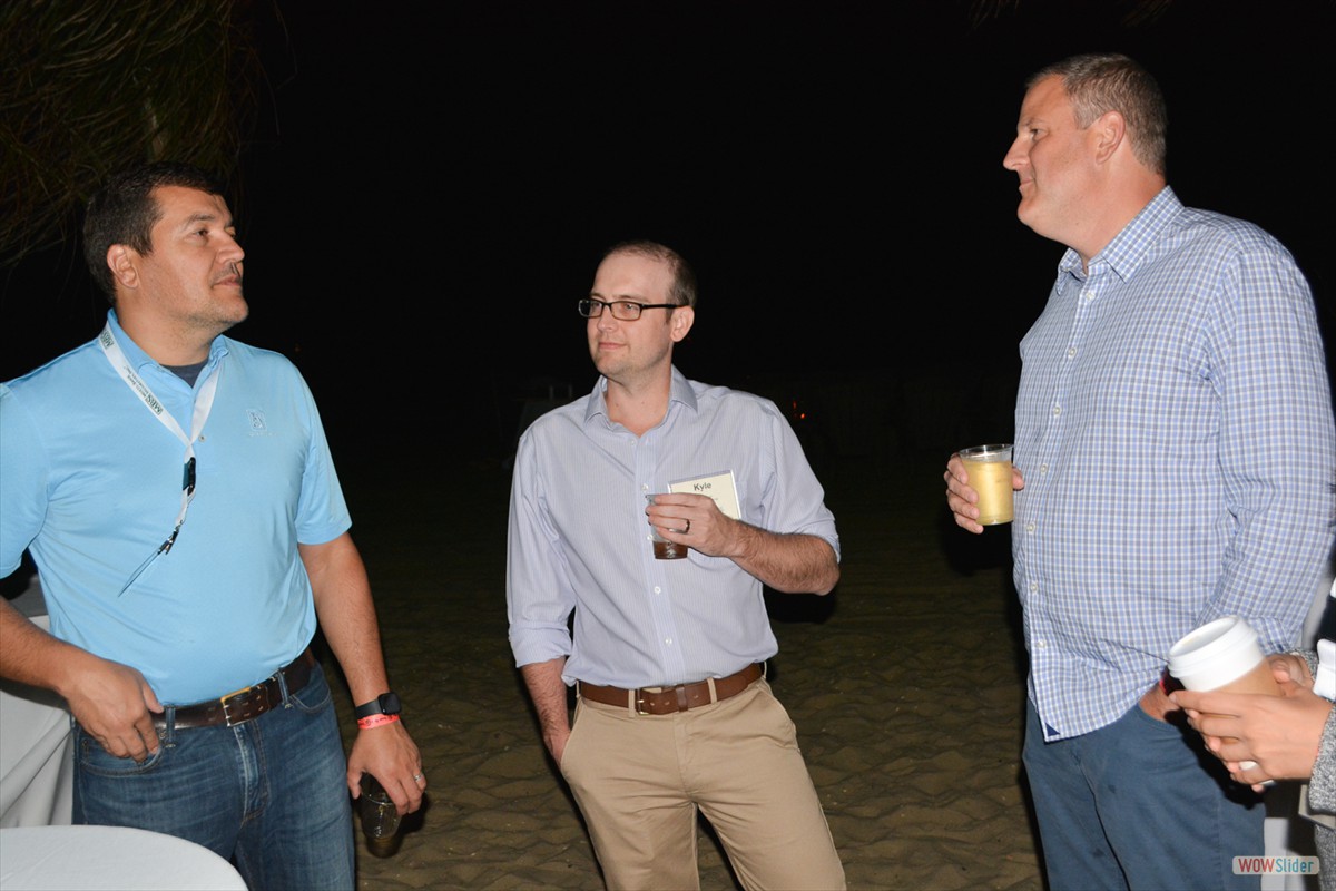 Members and guests enjoy the bonfire reception on the beach.