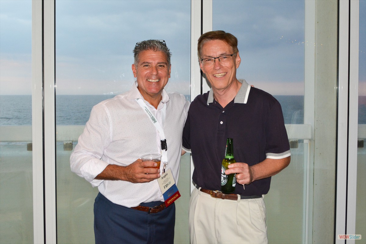 Chapter Secretary Angelo DiCaro (l.) joins Dave Lauwe at the cocktail hour.