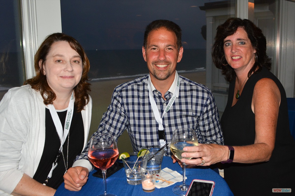 Immediate Past Chapter President Sal Zerillli (c.) smiles with Chapter Members at the cocktail hour.